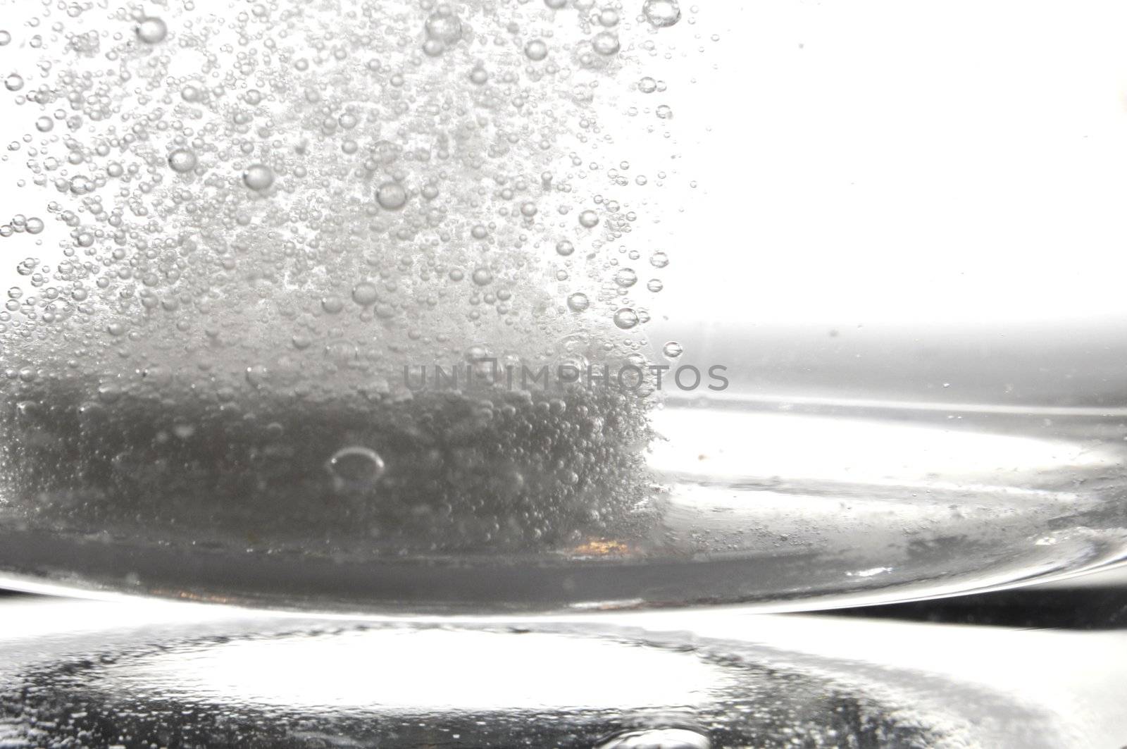 tablet or pain killer in a glass of water with copyspace