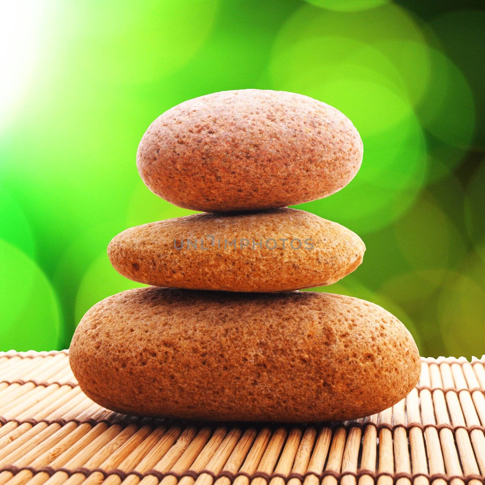 zen stones with green leaves and copyspace showing wellness