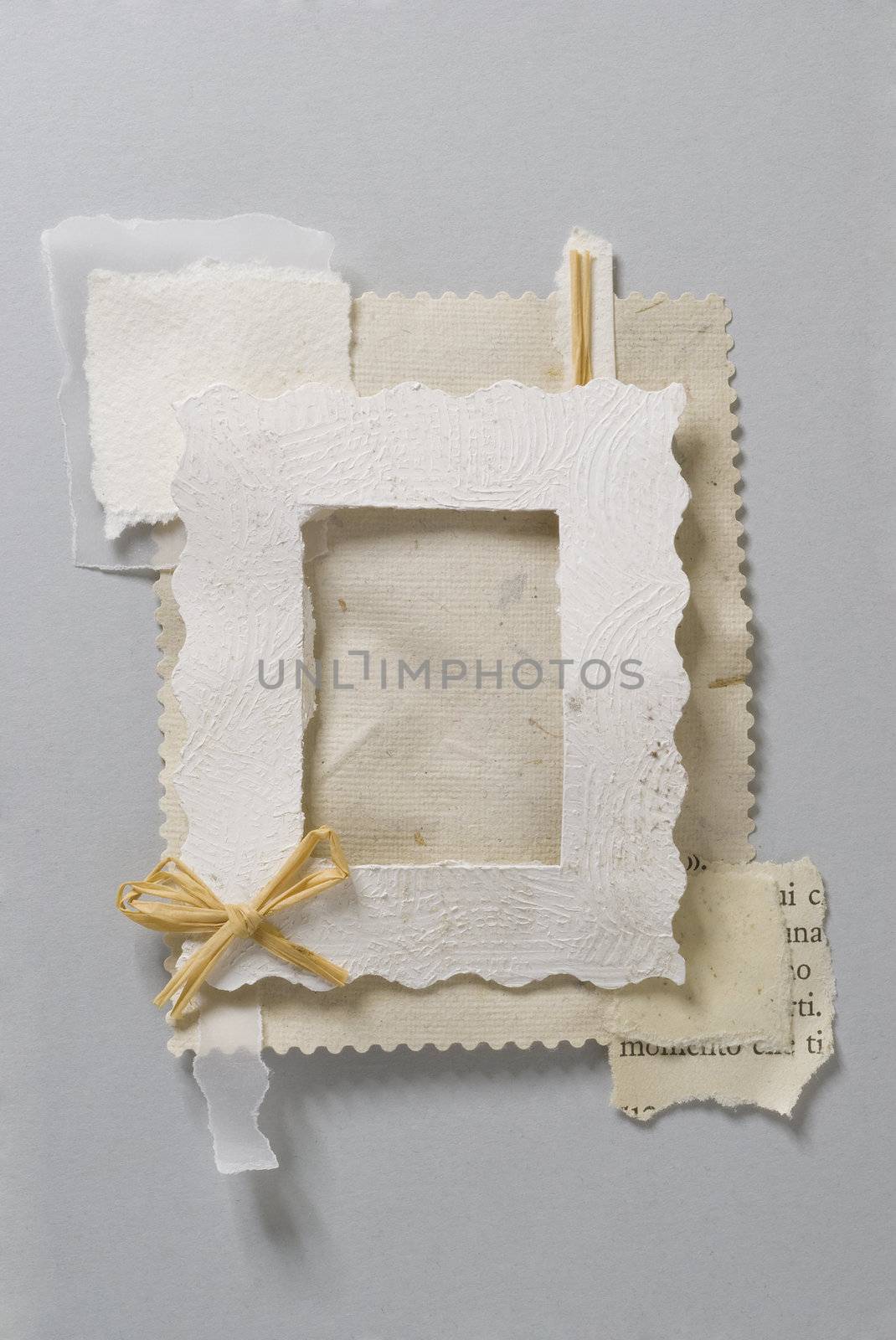 Paper frame made of pieces of paper with a little bow