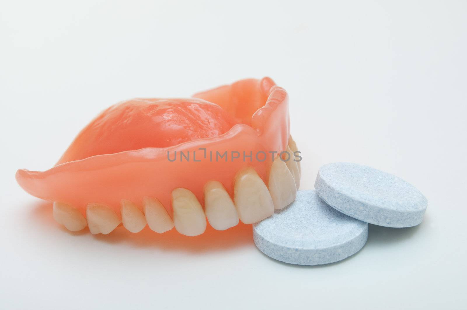 Close-up of denture with cleaning tablet