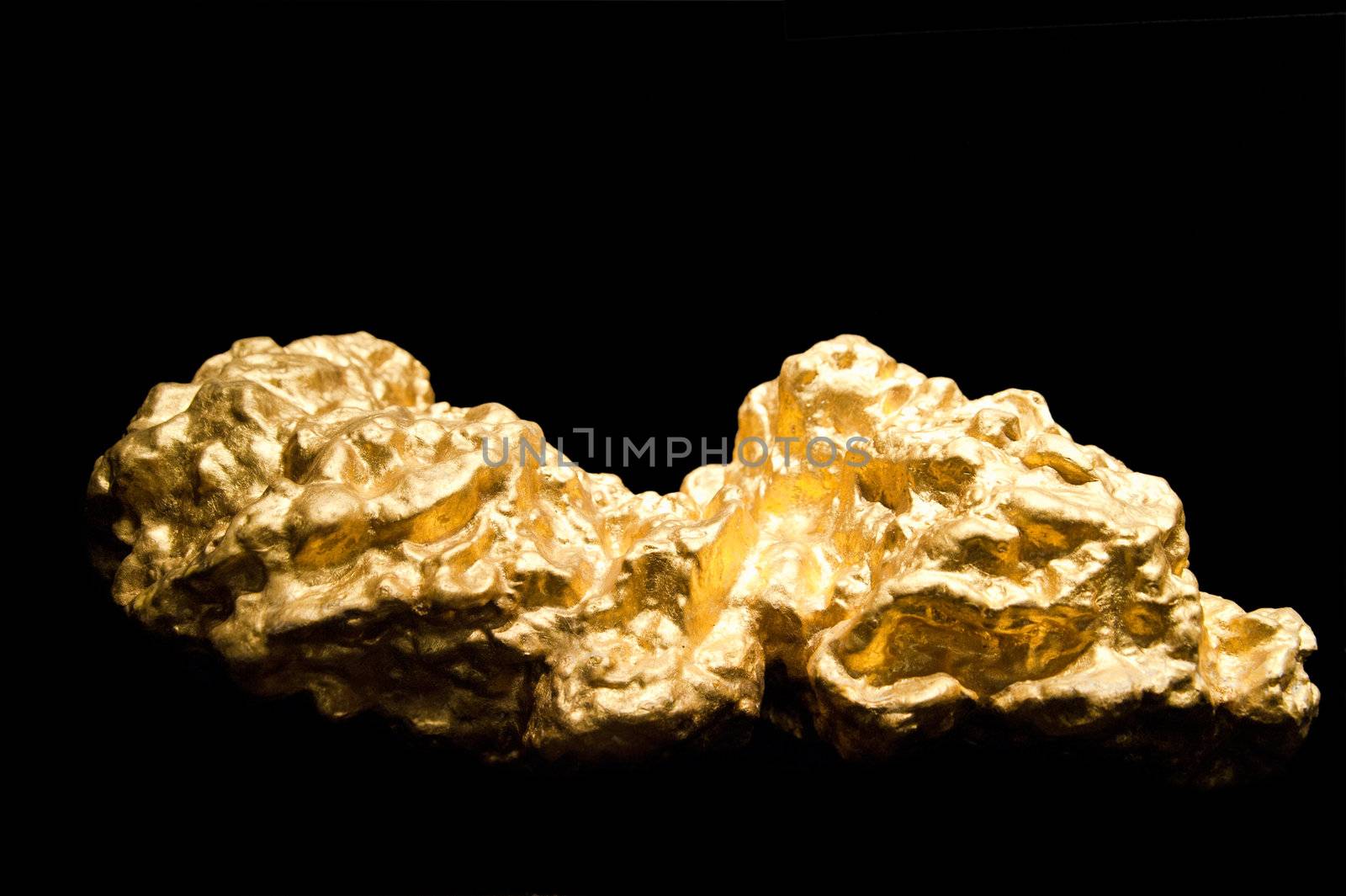 Nuggets of Gold on a black background with Shallow depth of field