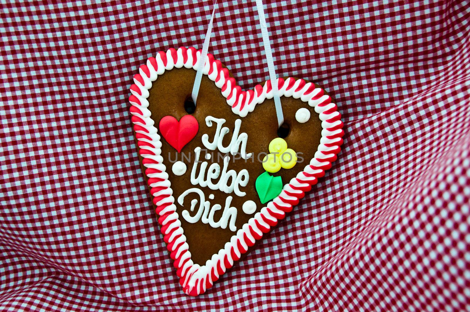 gingerbread Oktoberfest heart saying "I love you" on bavarian red checkered cloth