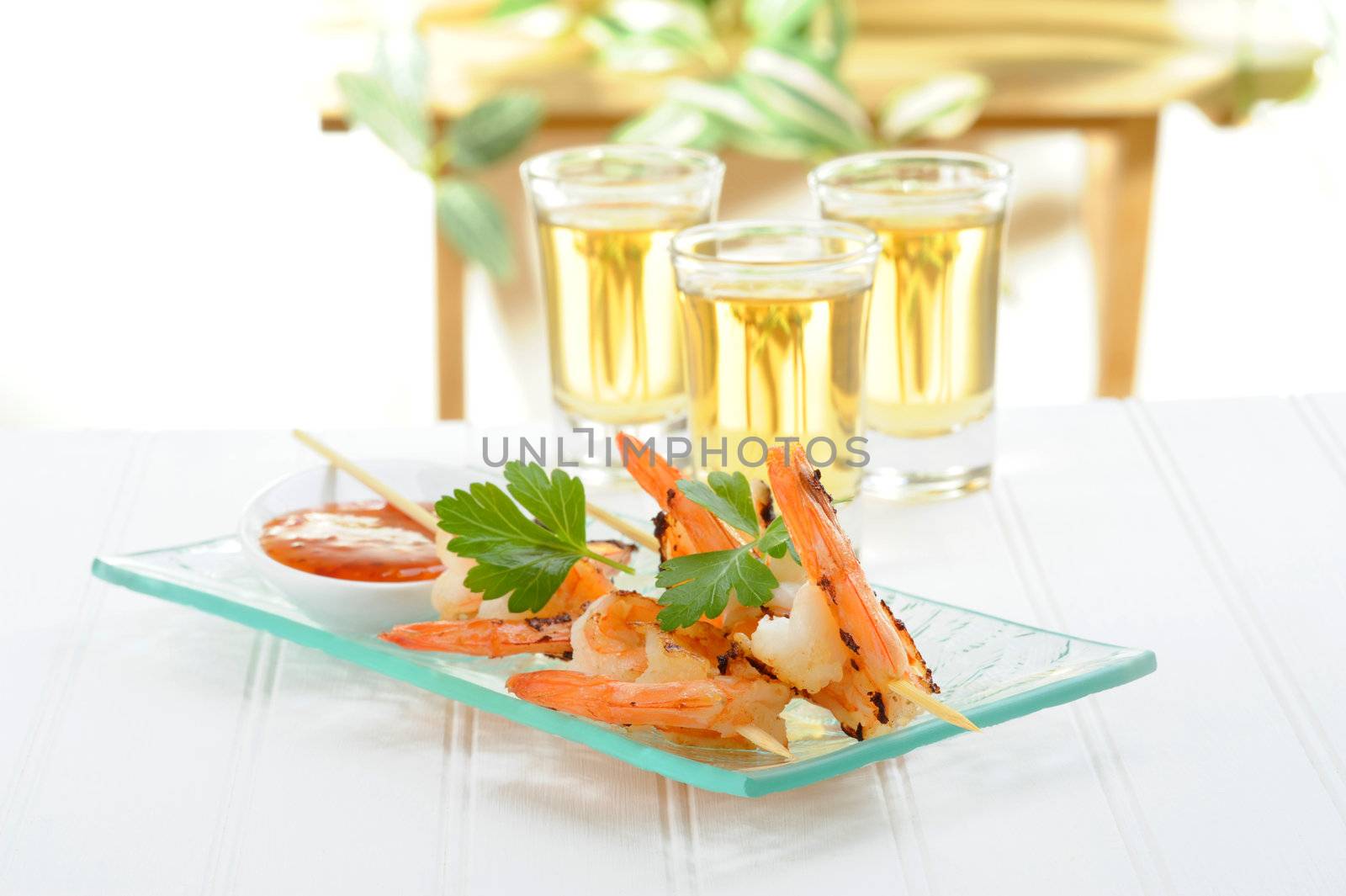 Shrimp skewers served with a spicy orange sauce.