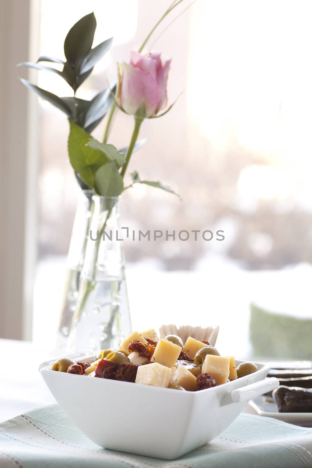 Cheese, sun dried tomatoes and stuffed olives appetizers.