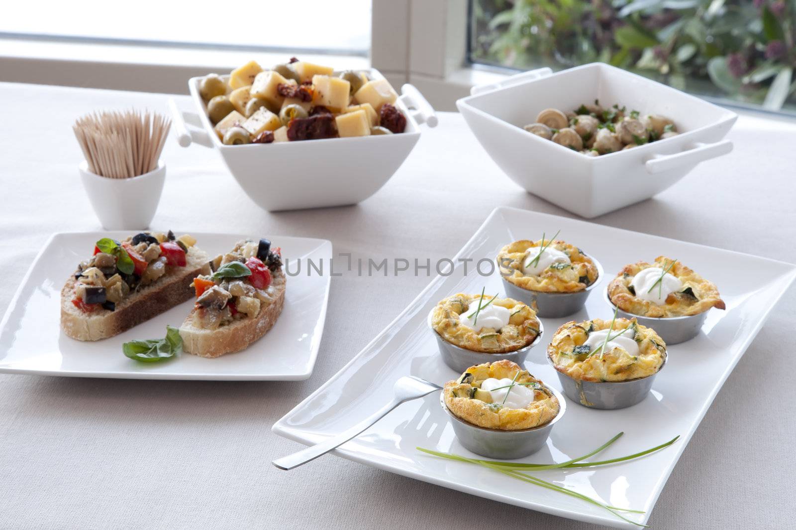 Tapas: bruschetta, fresh bite sized quiche, cheese and olive mix and marinated mushrooms.