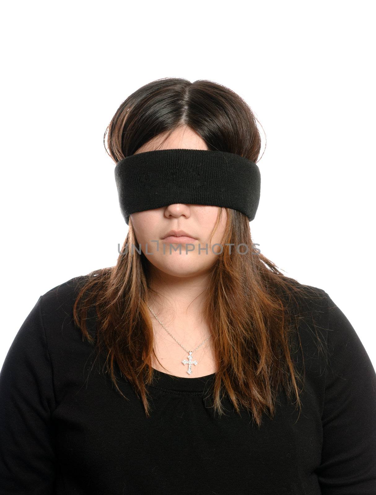 Closeup view of a blindfolded teenager who is wearing a cross necklace.  Could be used for Blind Faith.  Isolated against a white background.