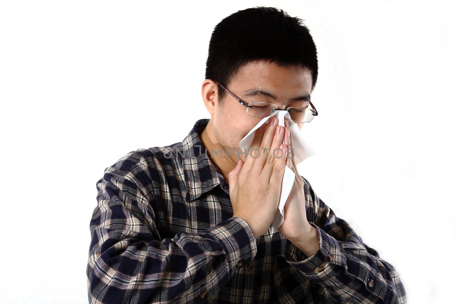 man blowing his nose close up