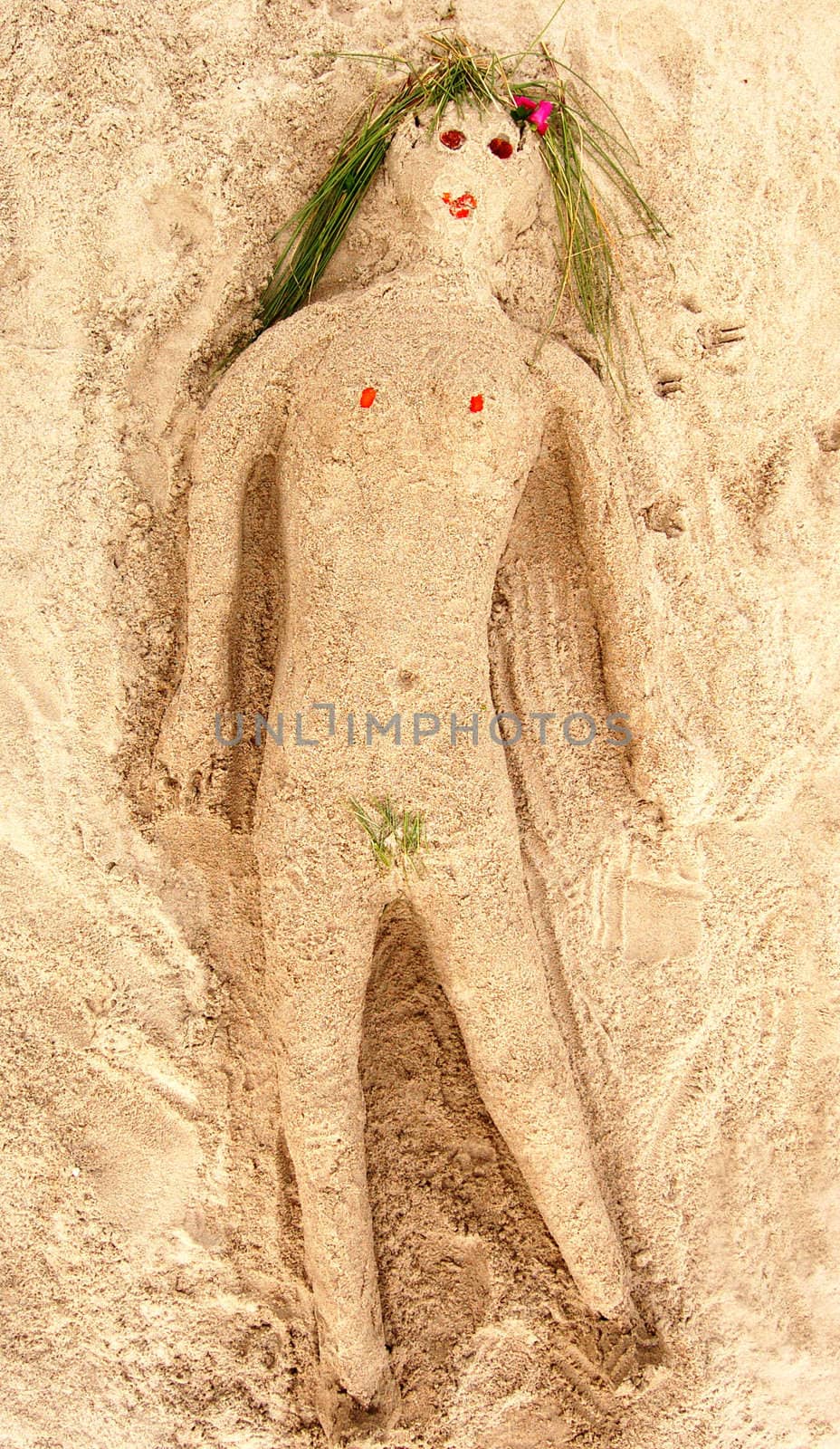 Woman made of sand on a beach.