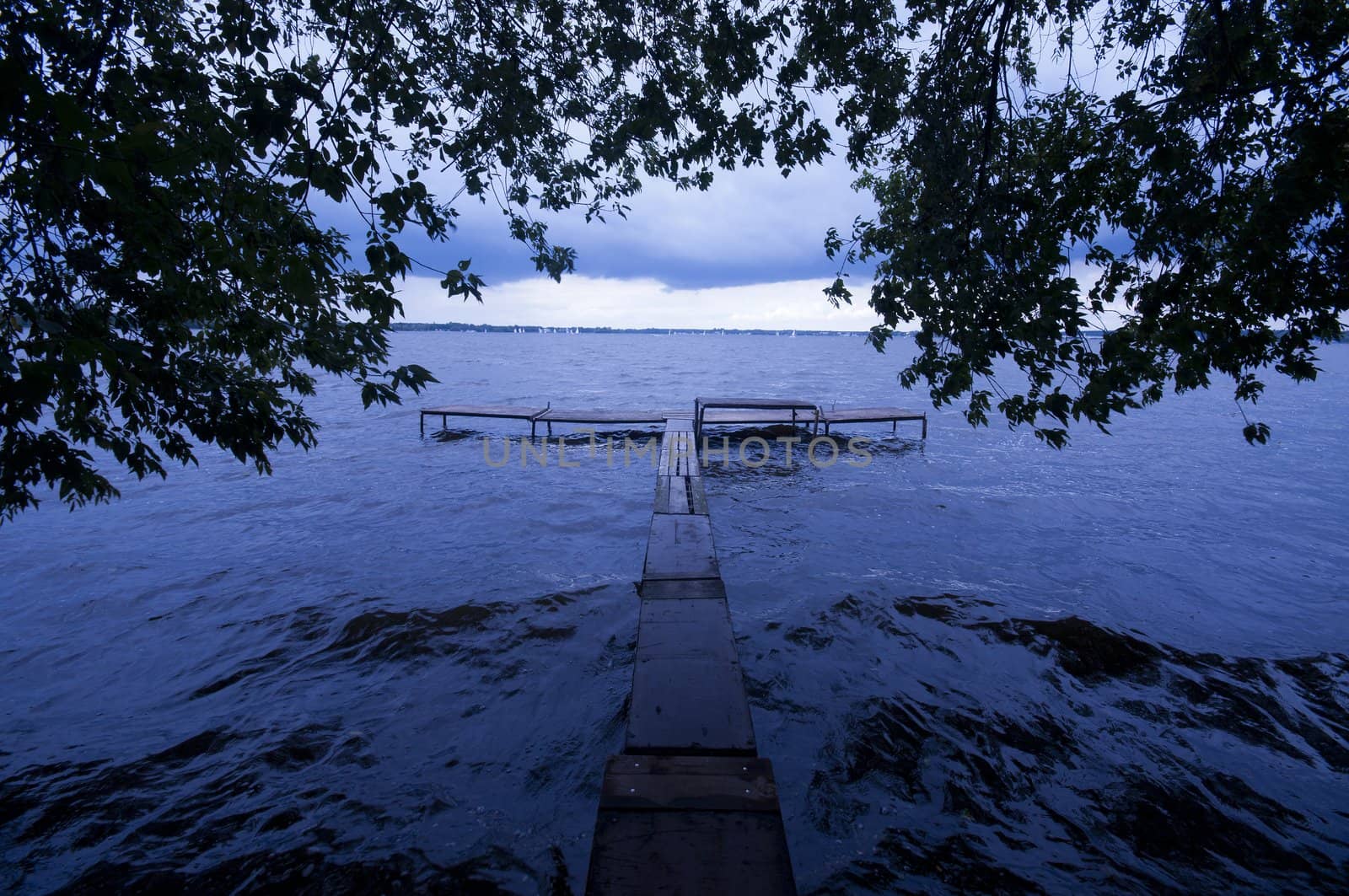 Old pier and dramatic sky by johnnychaos