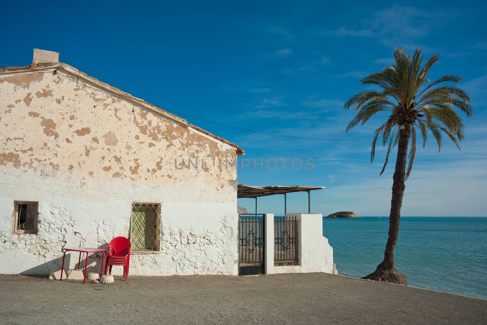 Traditional whitewashed Mediterranean house  located on a quiet beach
