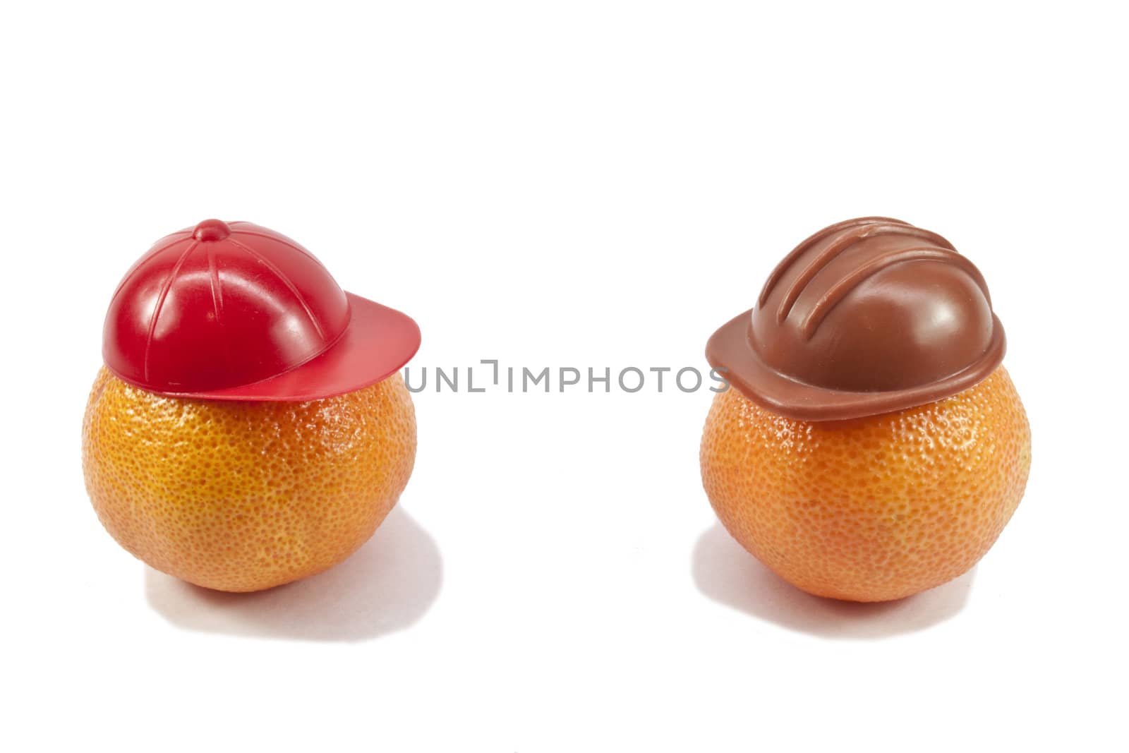 fresh tangerines in the headgear on a light background