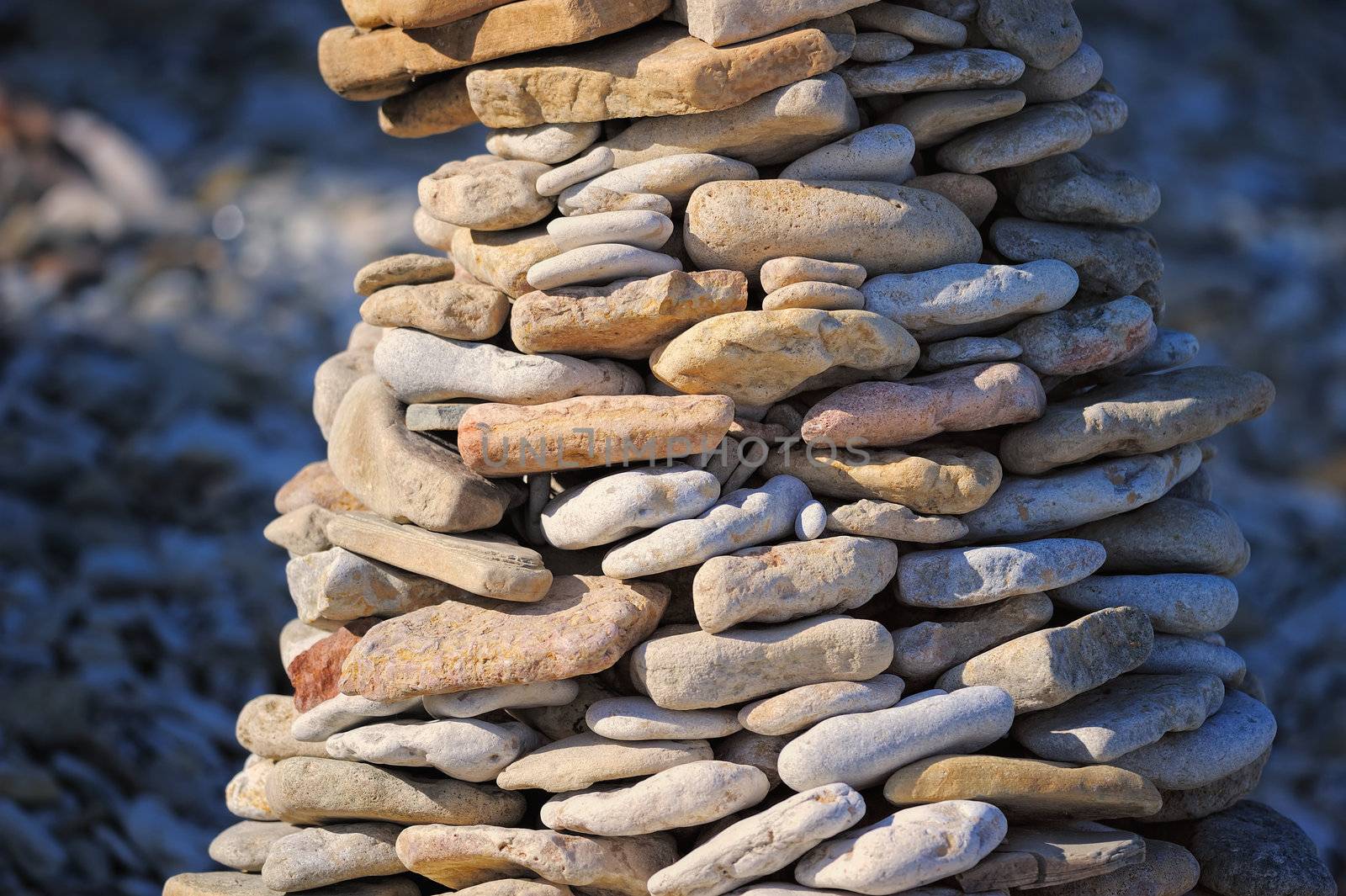 Stout pile of pebbles on the sea shore