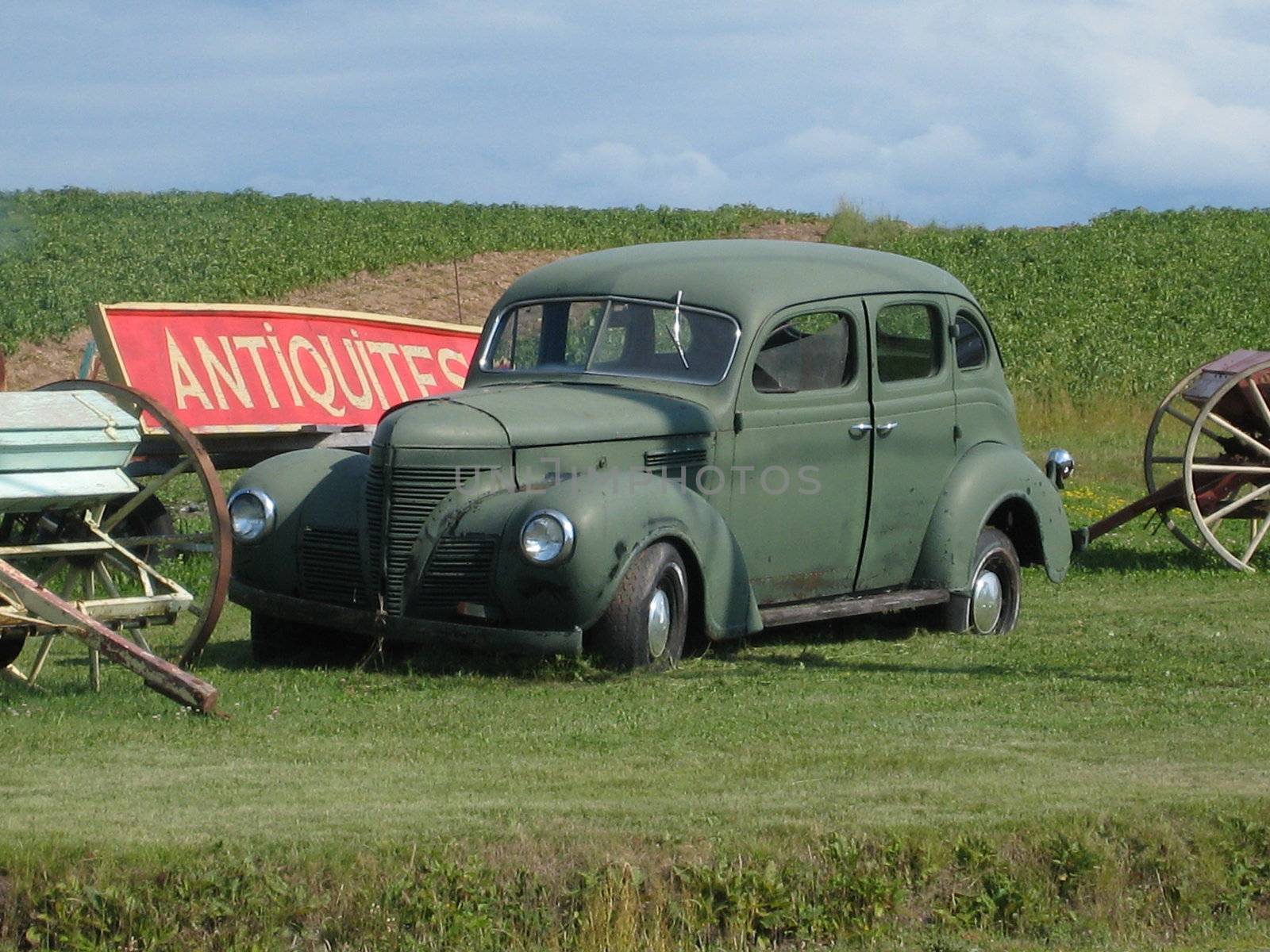 antic car abandoned in front of an antiquity shop, quebec