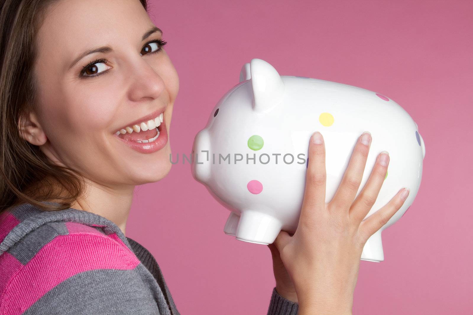 Pretty girl holding piggy bank