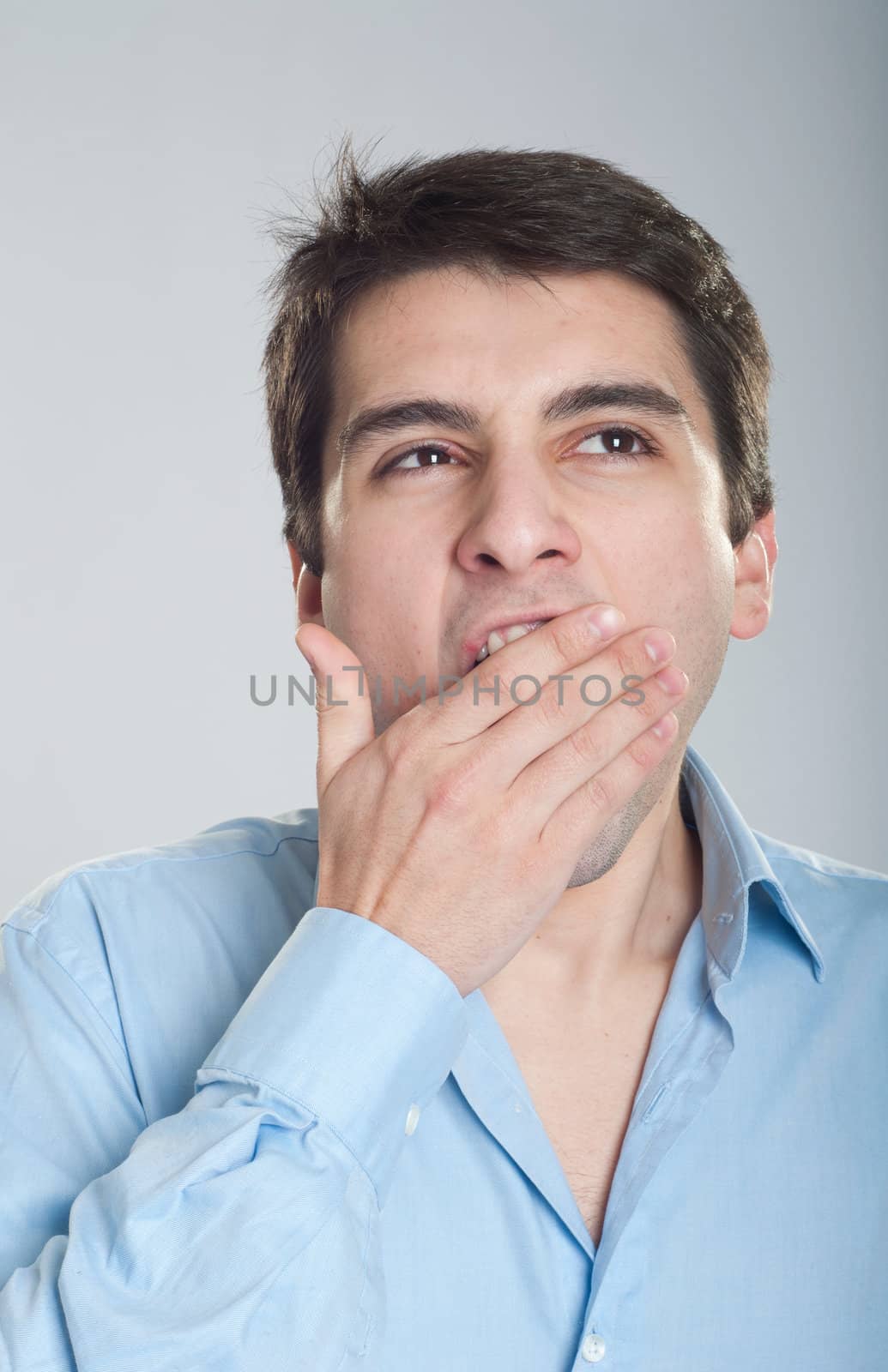 portrait of a young business man yawning