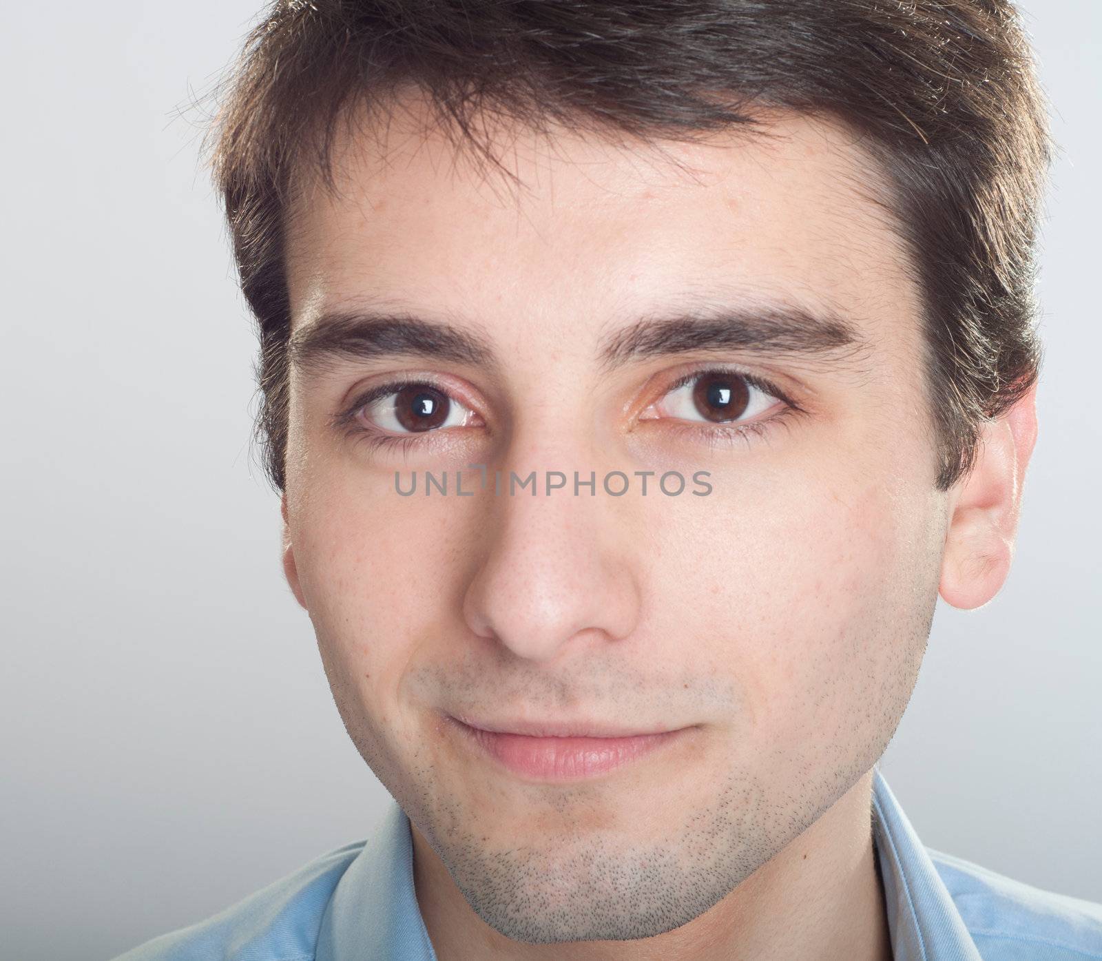 portrait of a smiling handsome trainee starting business career (close-up)