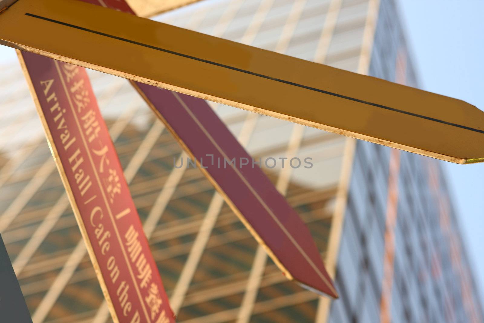 Concept image of a signpost against a modern glass office building 