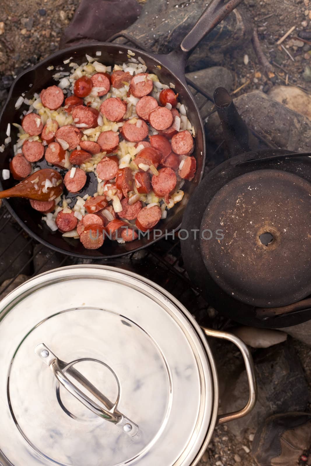 Cooking Dinner on campfire in cast iron pan.