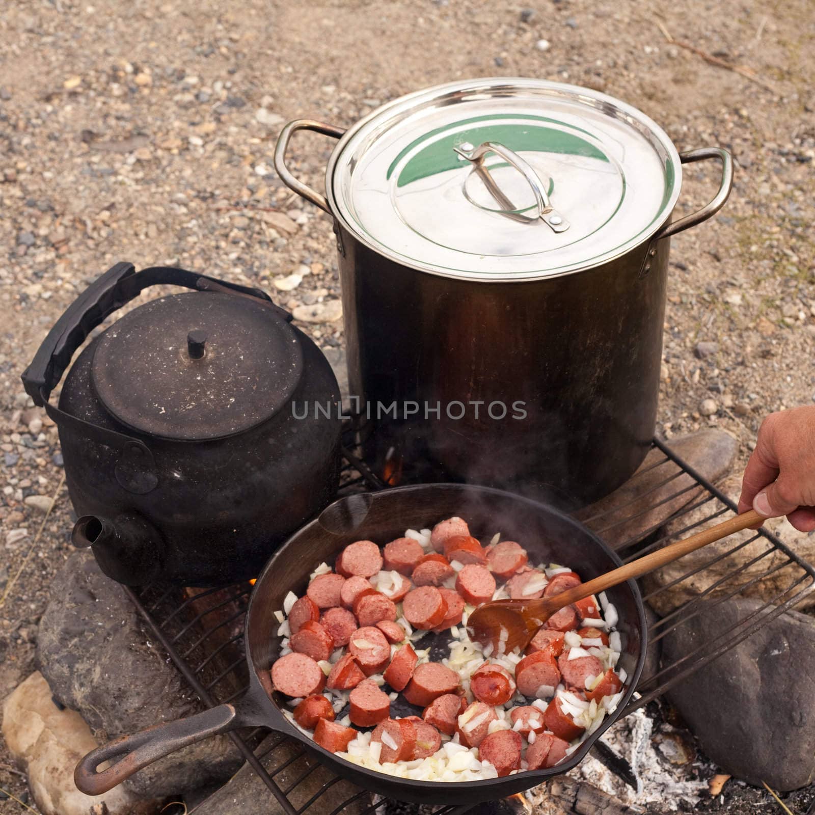 Cooking Dinner on campfire in cast iron pan.