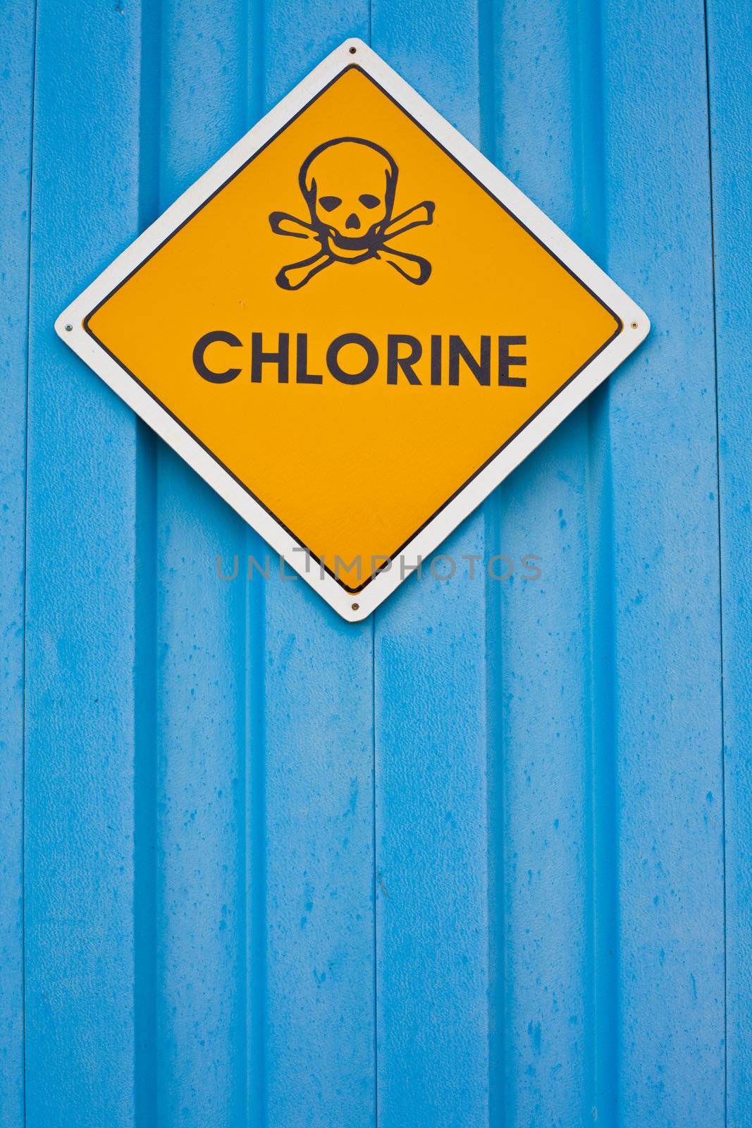 Chlorine warning sign with skull and crossbones on blue background.