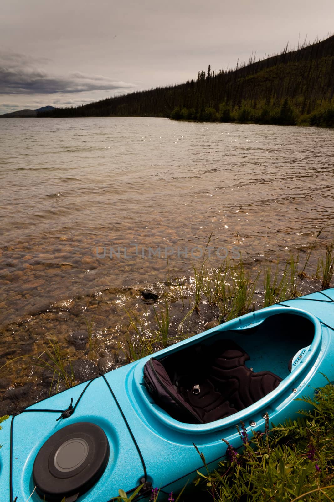 Kayak ready to go on lake shore