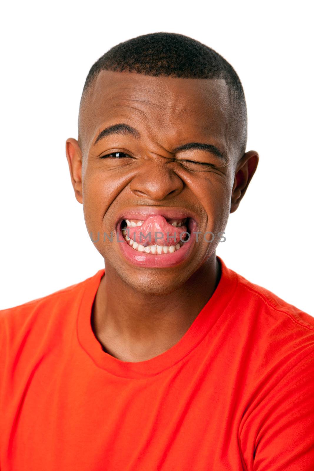 Young man with humorous funny expression sticking tongue out face, isolated.