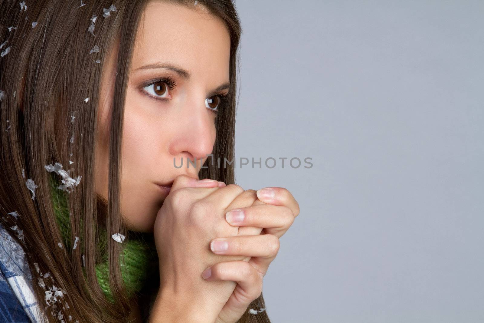 Cold woman blowing on hands