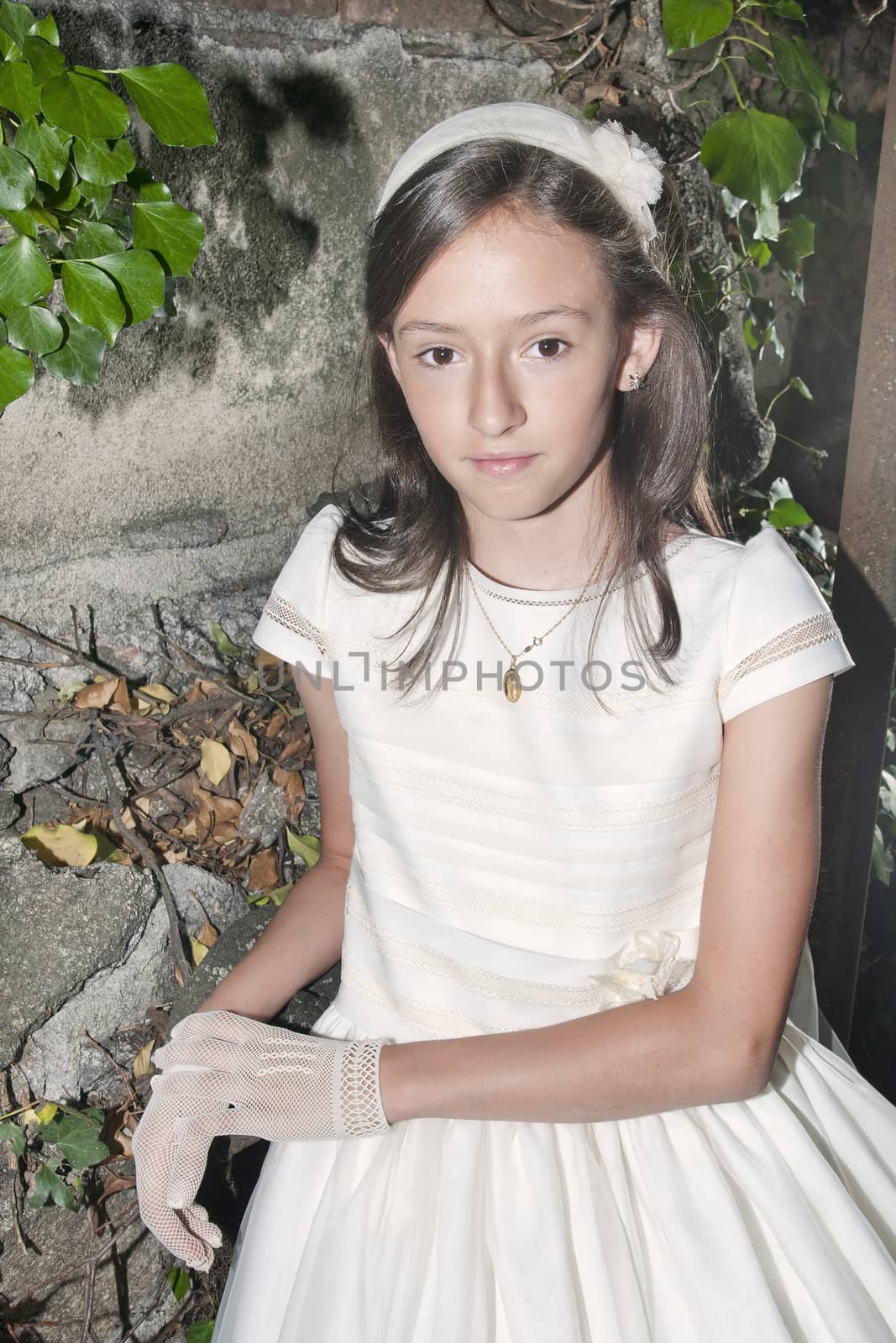 girl white dress the day of their first communion
