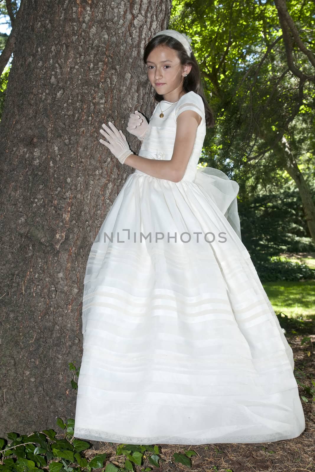 girl white dress the day of their first communion

