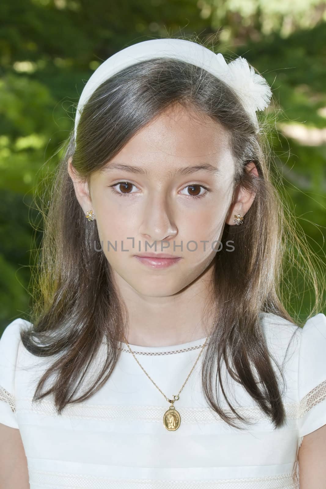 girl white dress the day of their first communion
