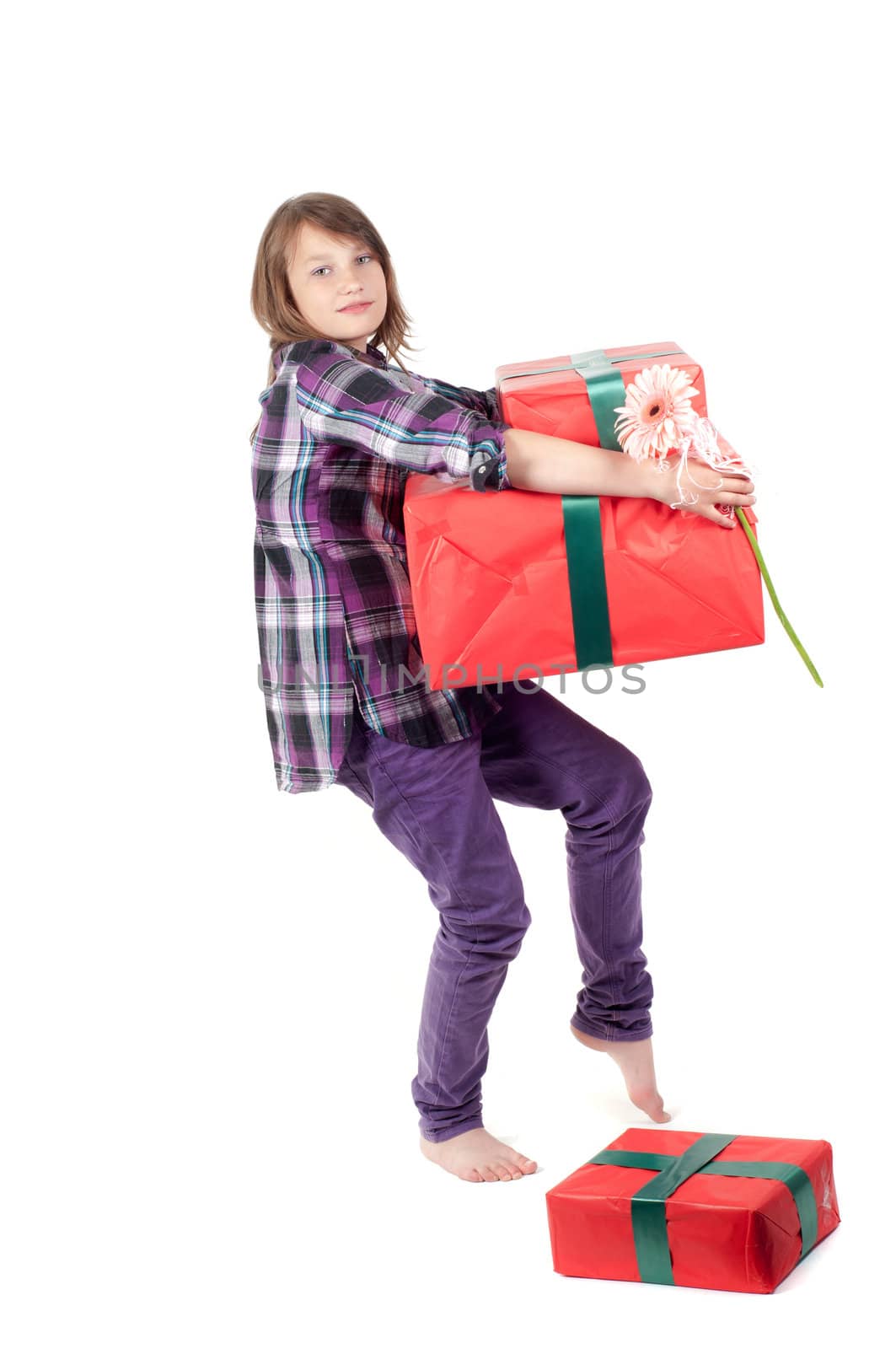 Teenager girl with presents in studio isolated on white