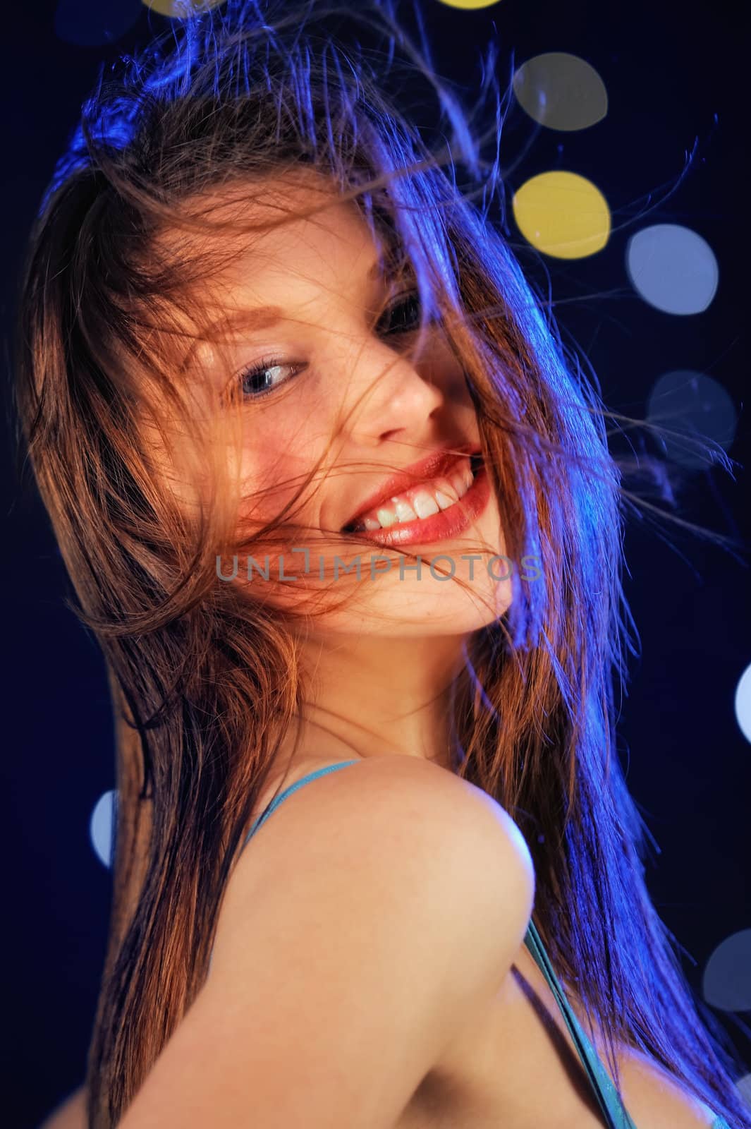 Young woman smiling. On the night disco