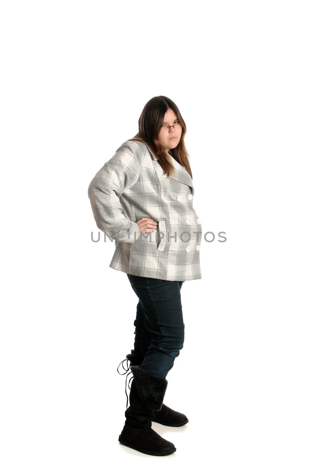 A full body view of a teenage girl looking mad and showing attitude, isolated against a white background.
