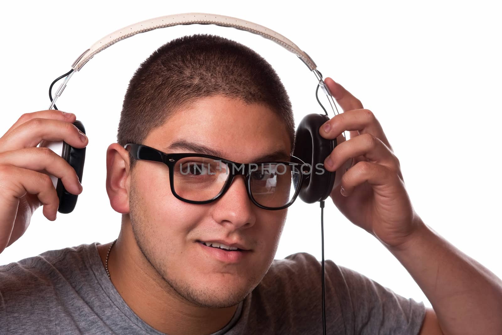 A young man listens to music with a set of head phones.