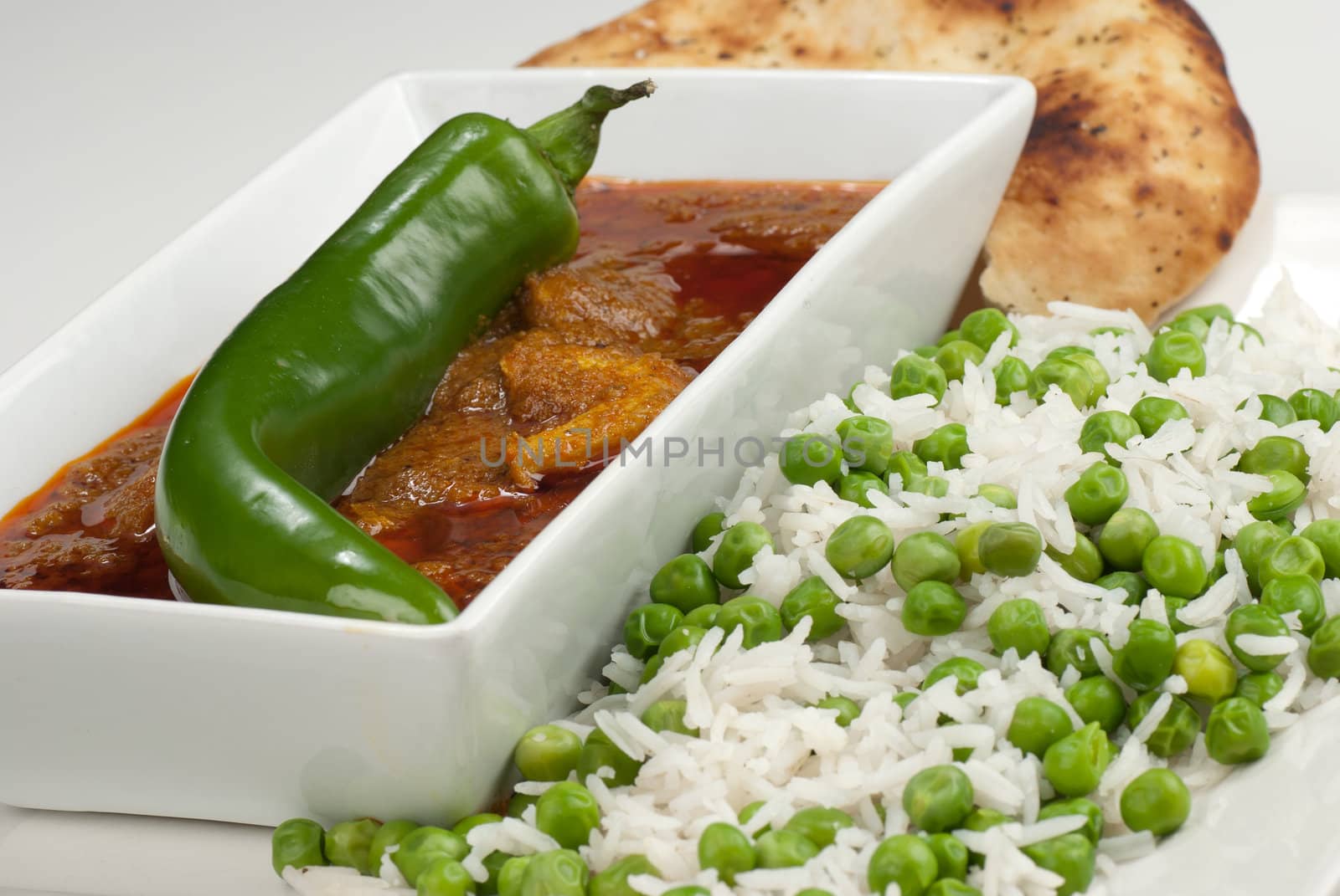 Chicken Madras curry served with rice and naan bread