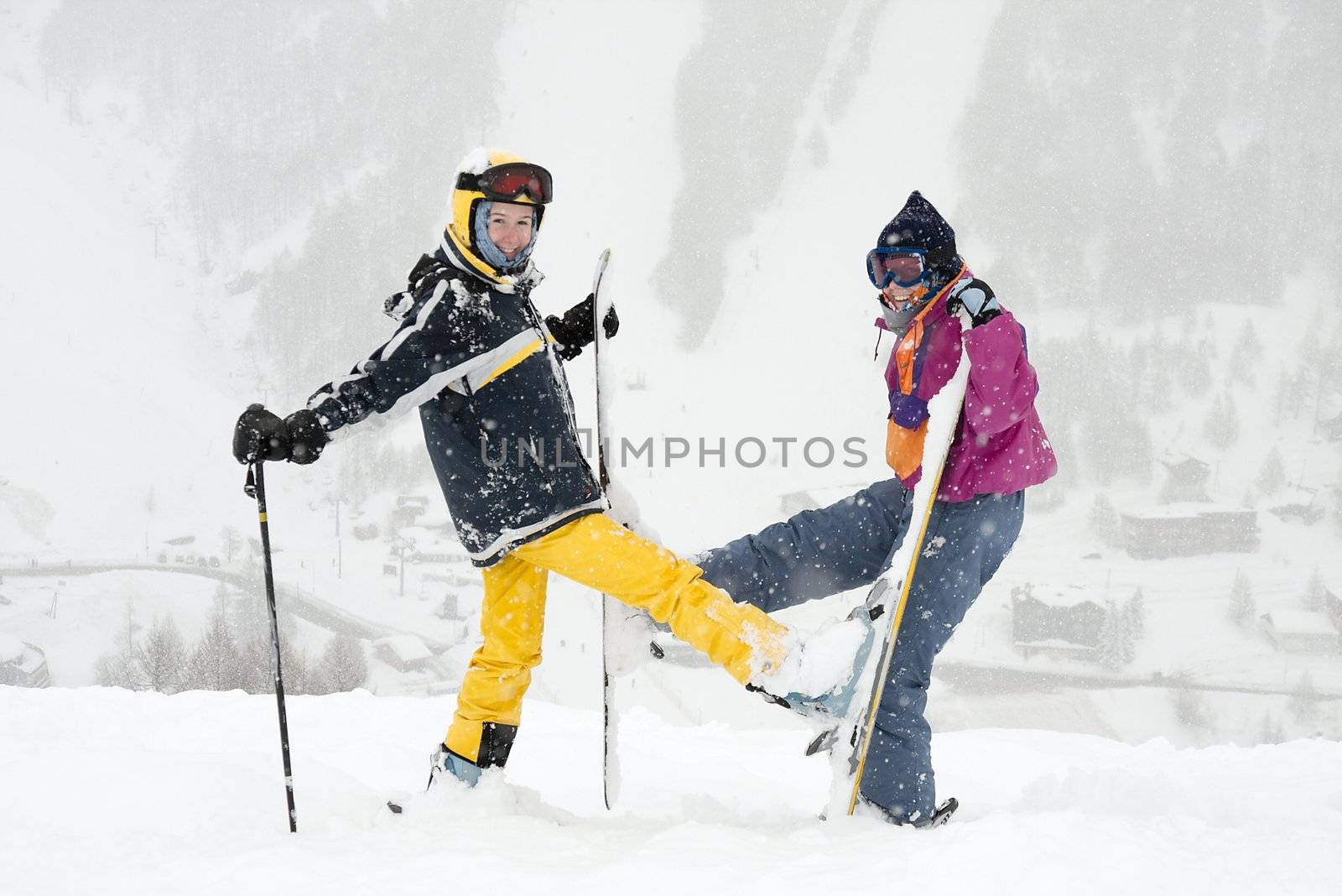 Young female skiers having fun in the falling snow