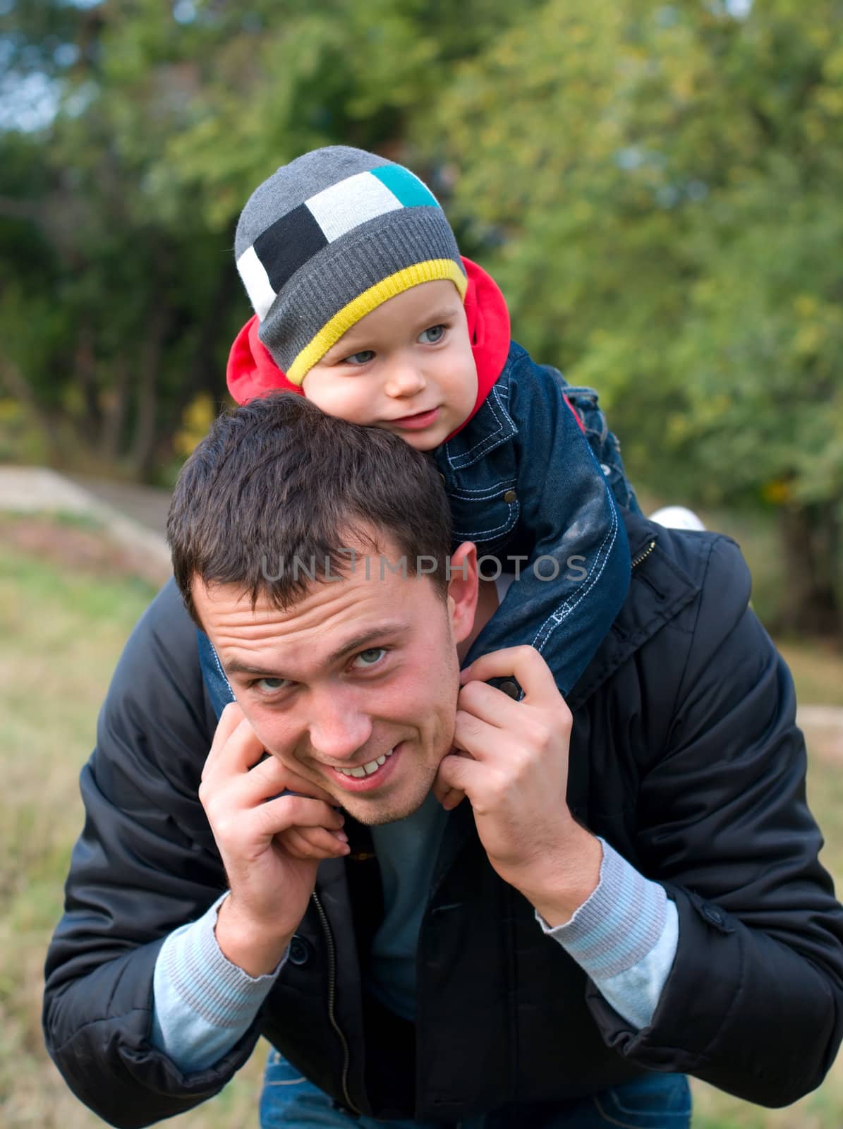Happy father and son in a park in autumn