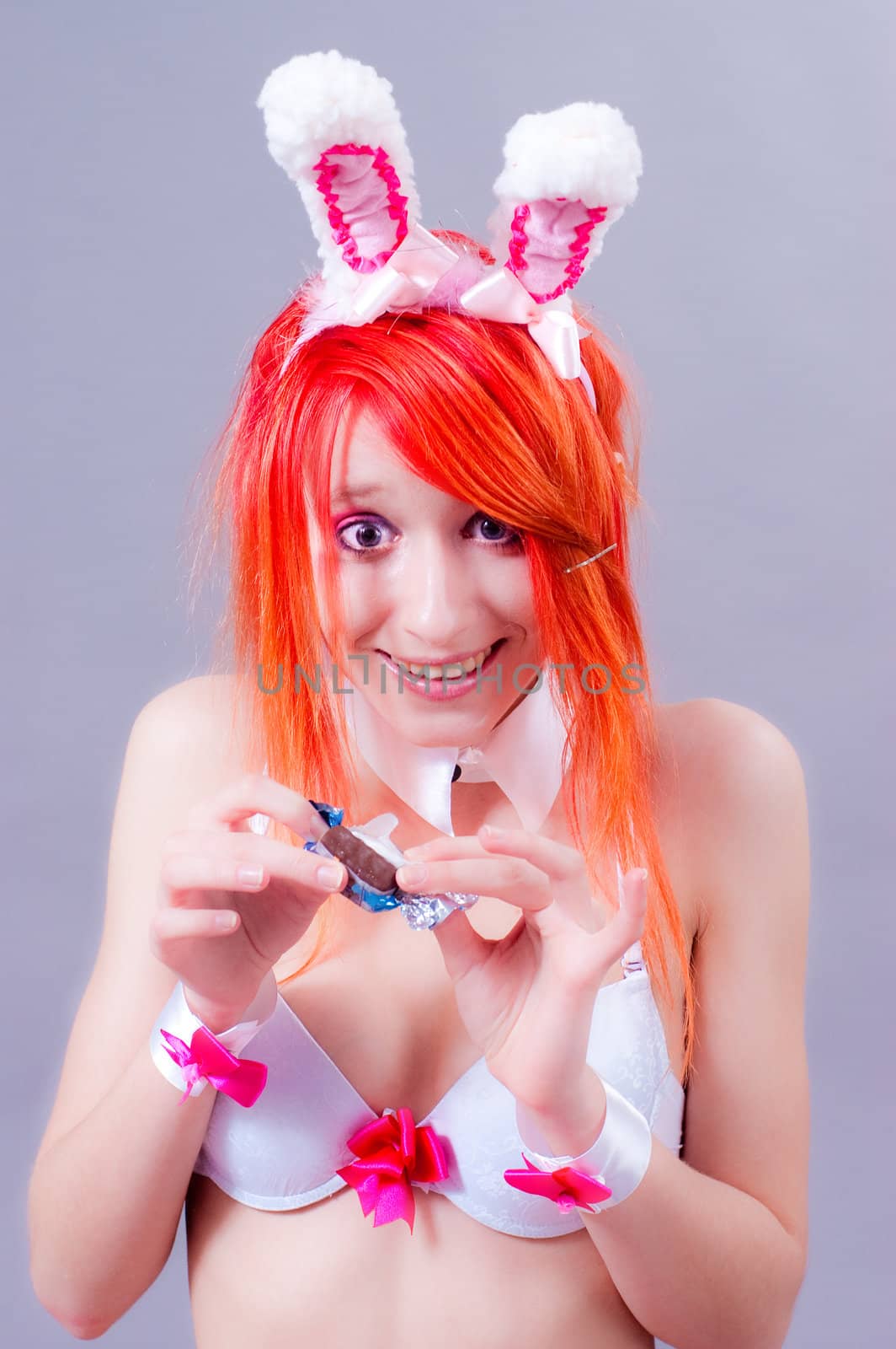 woman easter bunny on gray background with orange hair