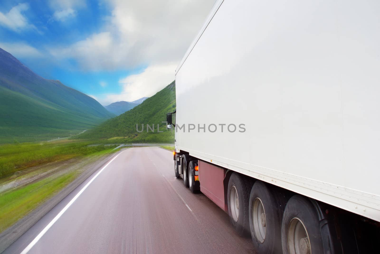 Motion of white semi-truck on the mountain road 