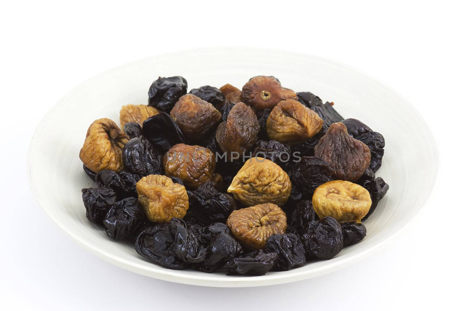 dried plums and figs on a plate
