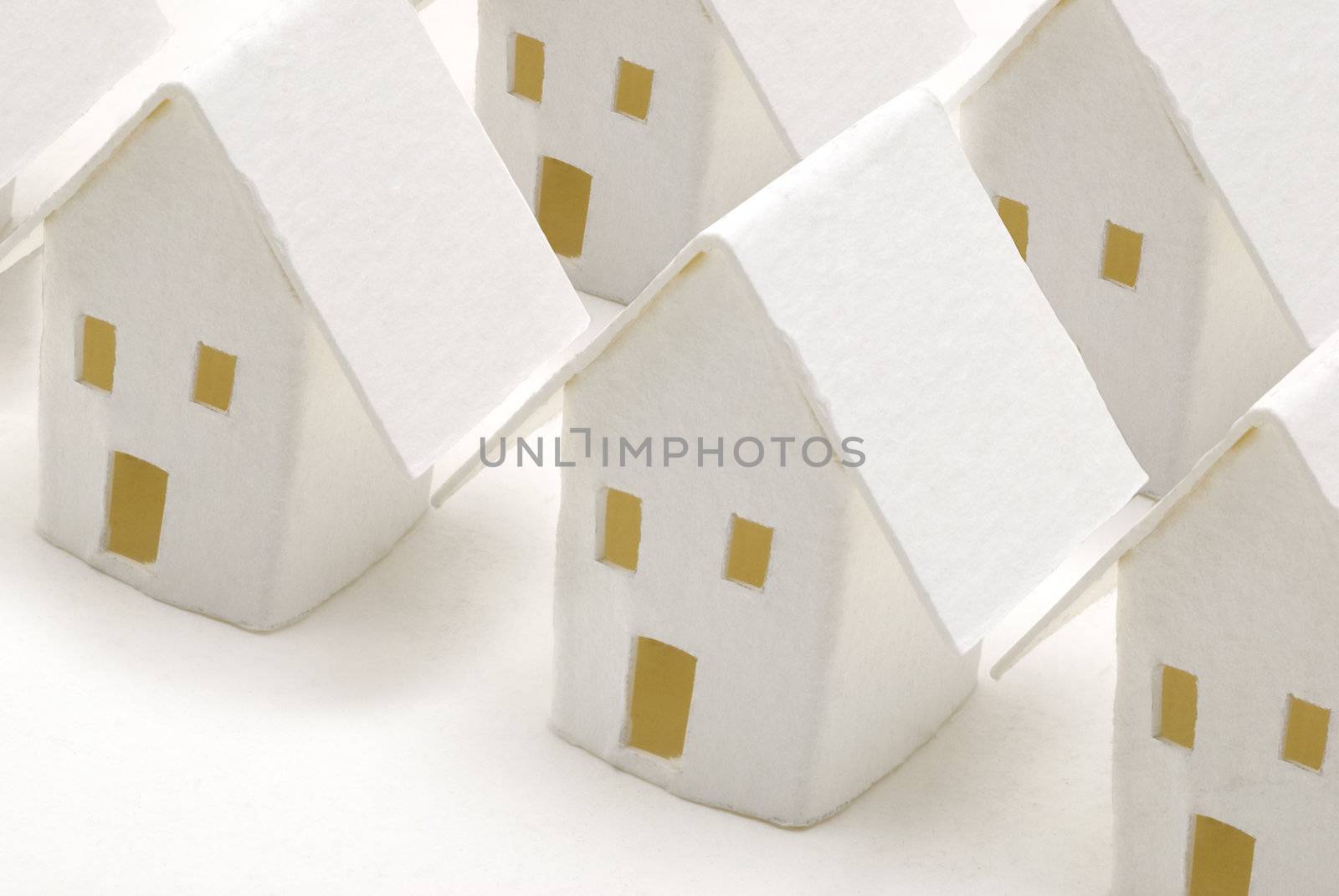 Some houses made of paper aligned together