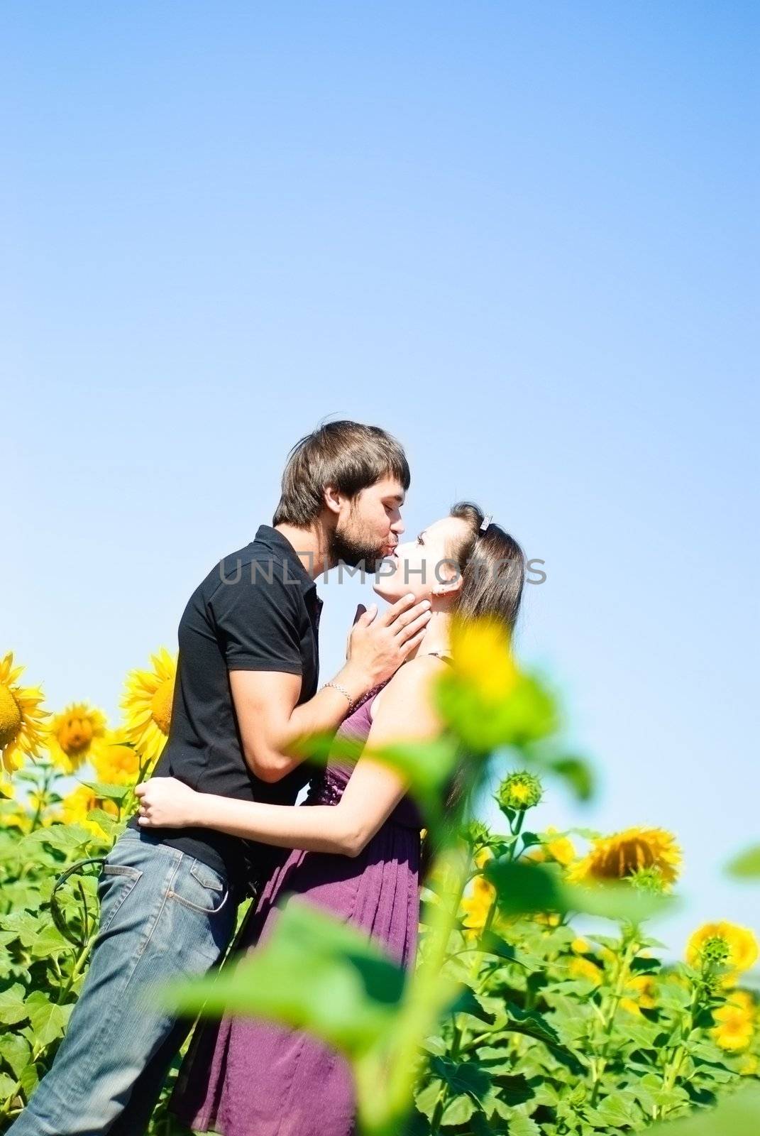 Young happy couple on the field. Shoot on the nature.