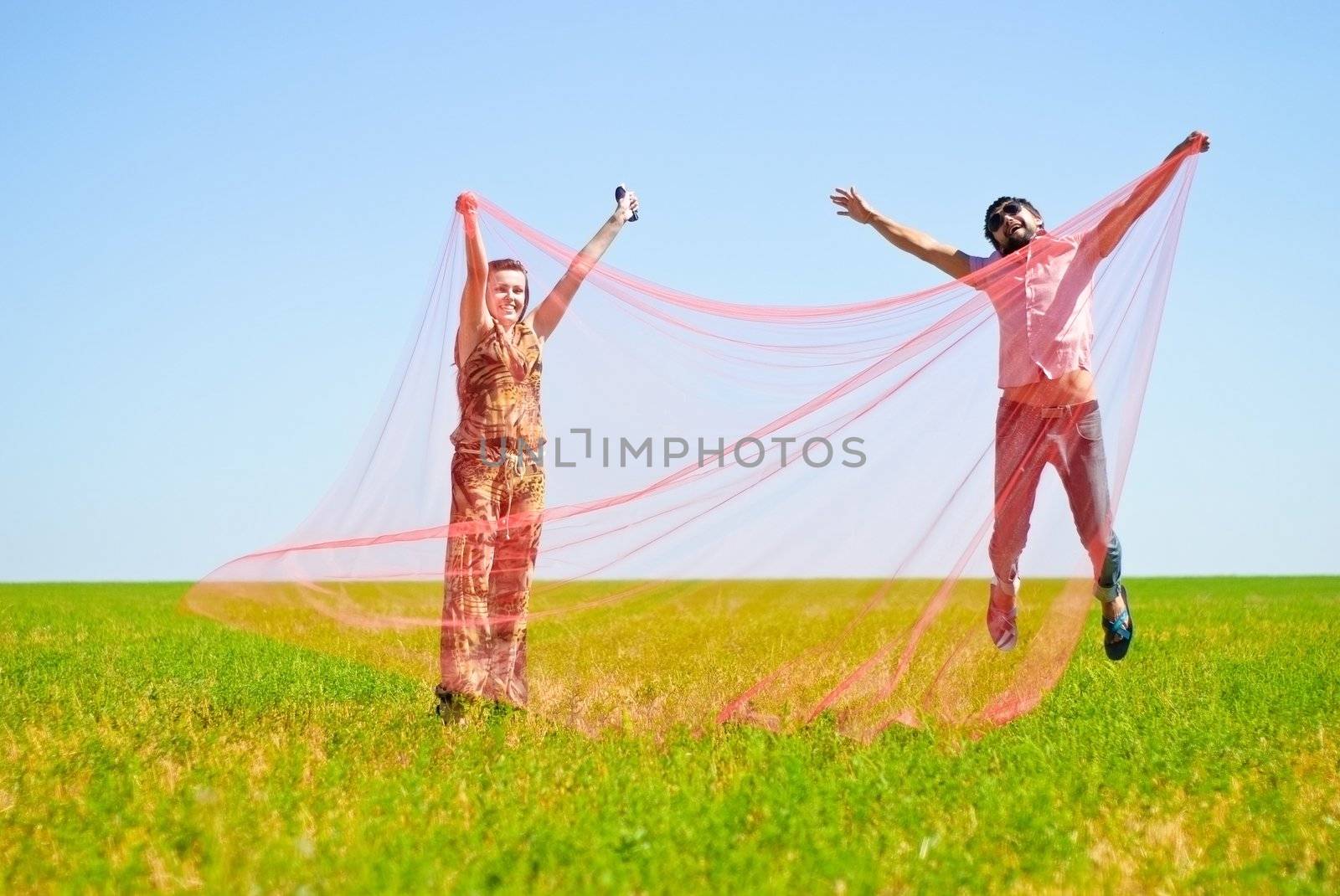 Young happy couple on the field. Shoot on the nature.