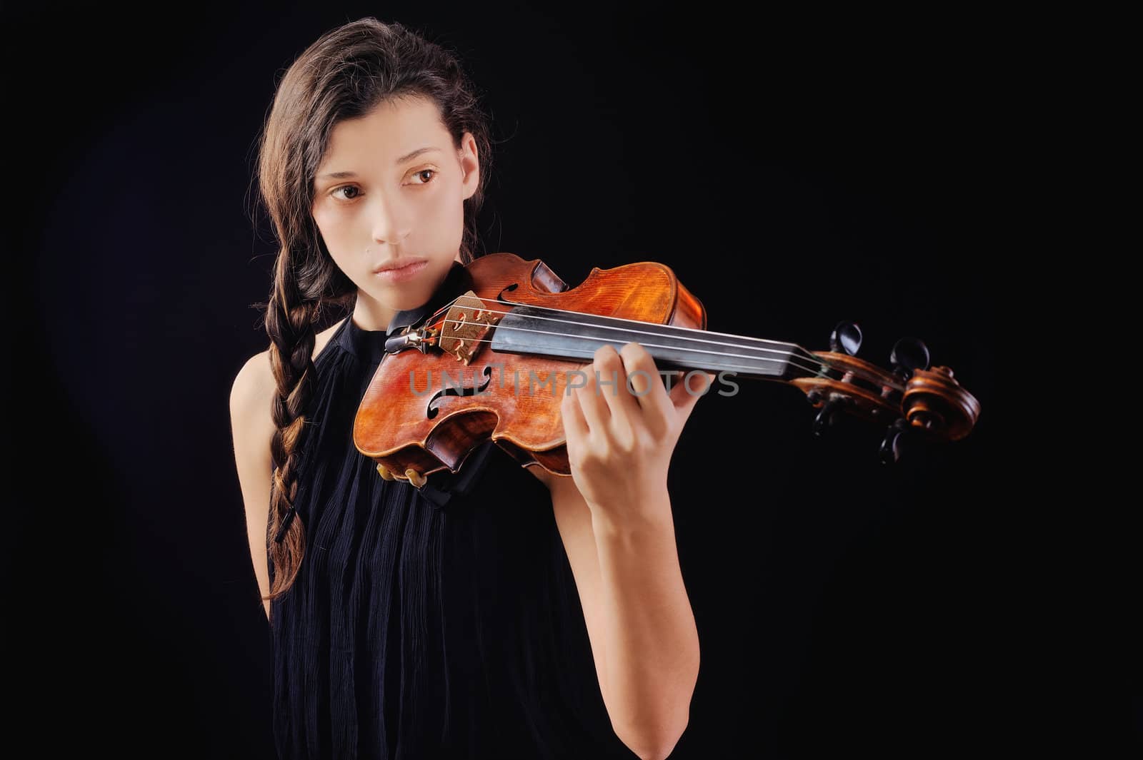 Musician playing violin. Isolated on the black background