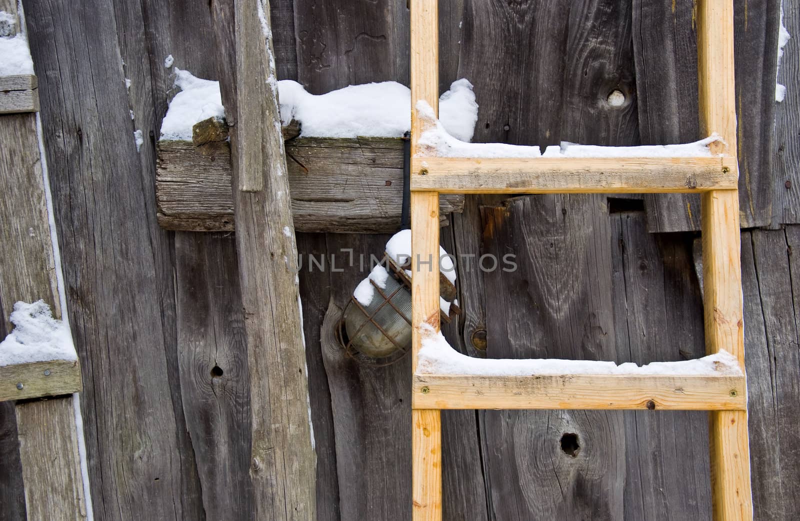 Old wooden barn wall. Wooden stairs and an old lamp. Rural life