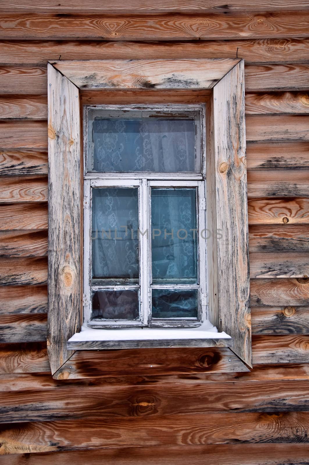 Old rustic wall with a window. Fragment, close-up. Rural life.