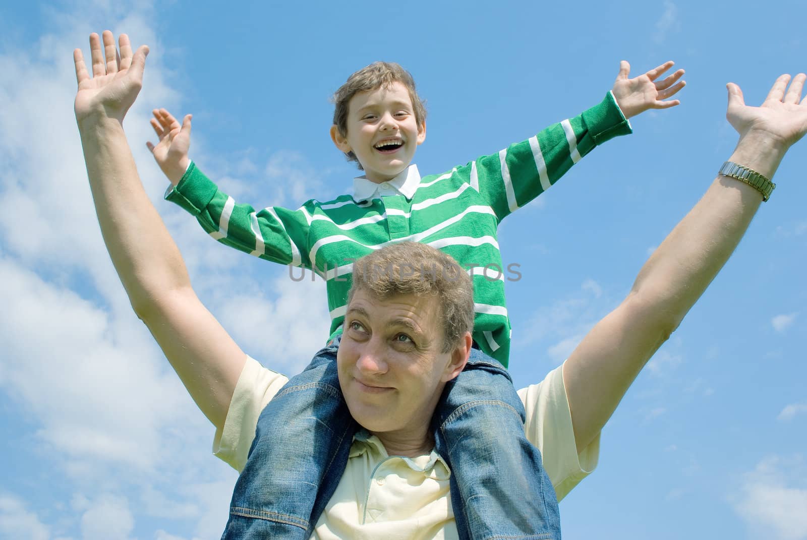 Father and his son against the blue sky