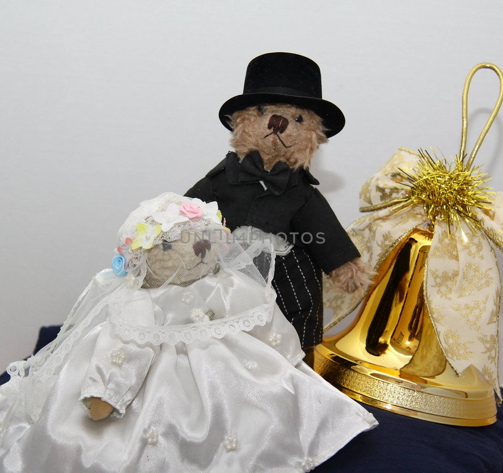 bridal couple of cute teddy bears with a golden bell with the concept of a christmas wedding.