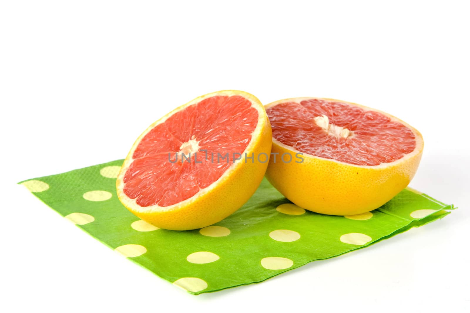 a grapefruit on a dotted napkin