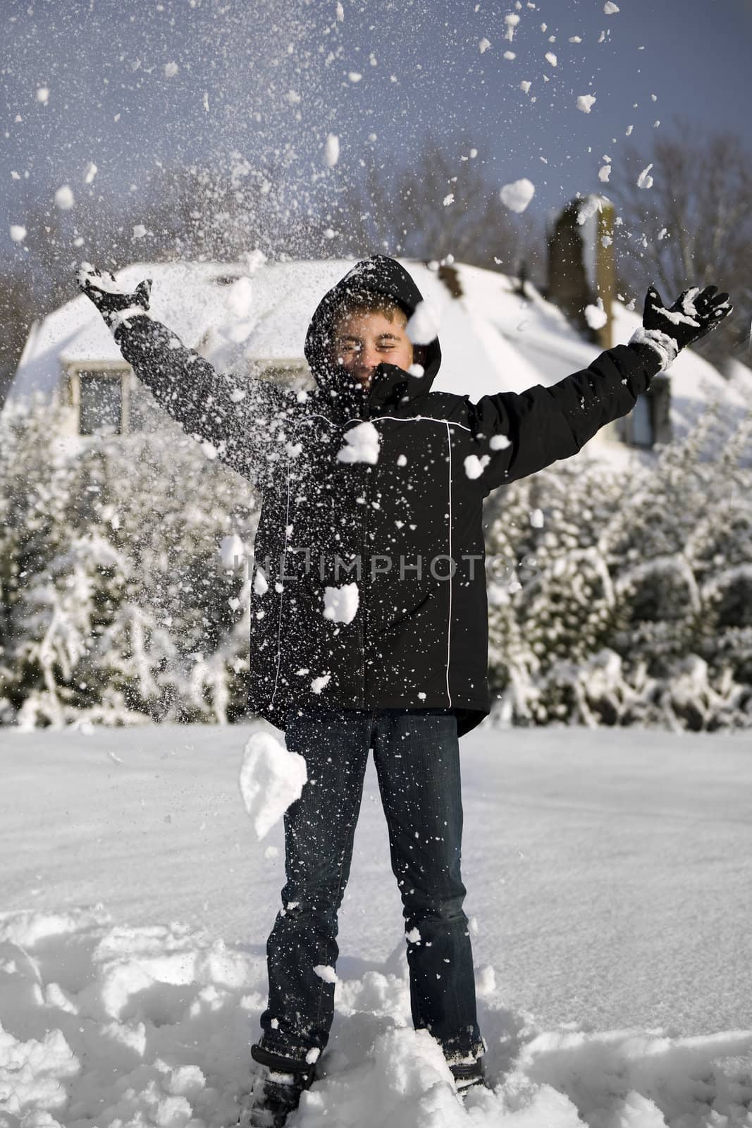 a young boy in the snow having fun